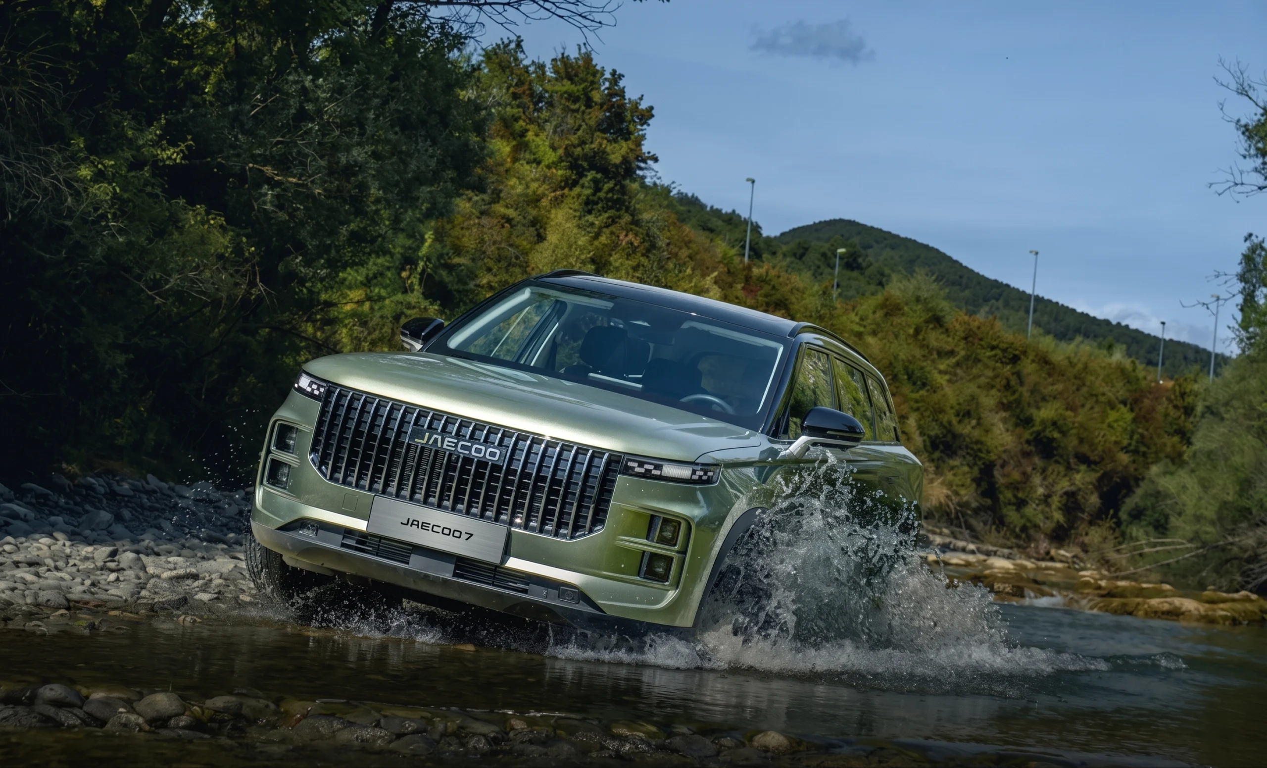 A JAECOO 7 fording a river, with the DRIVE POWER wordmark behind it